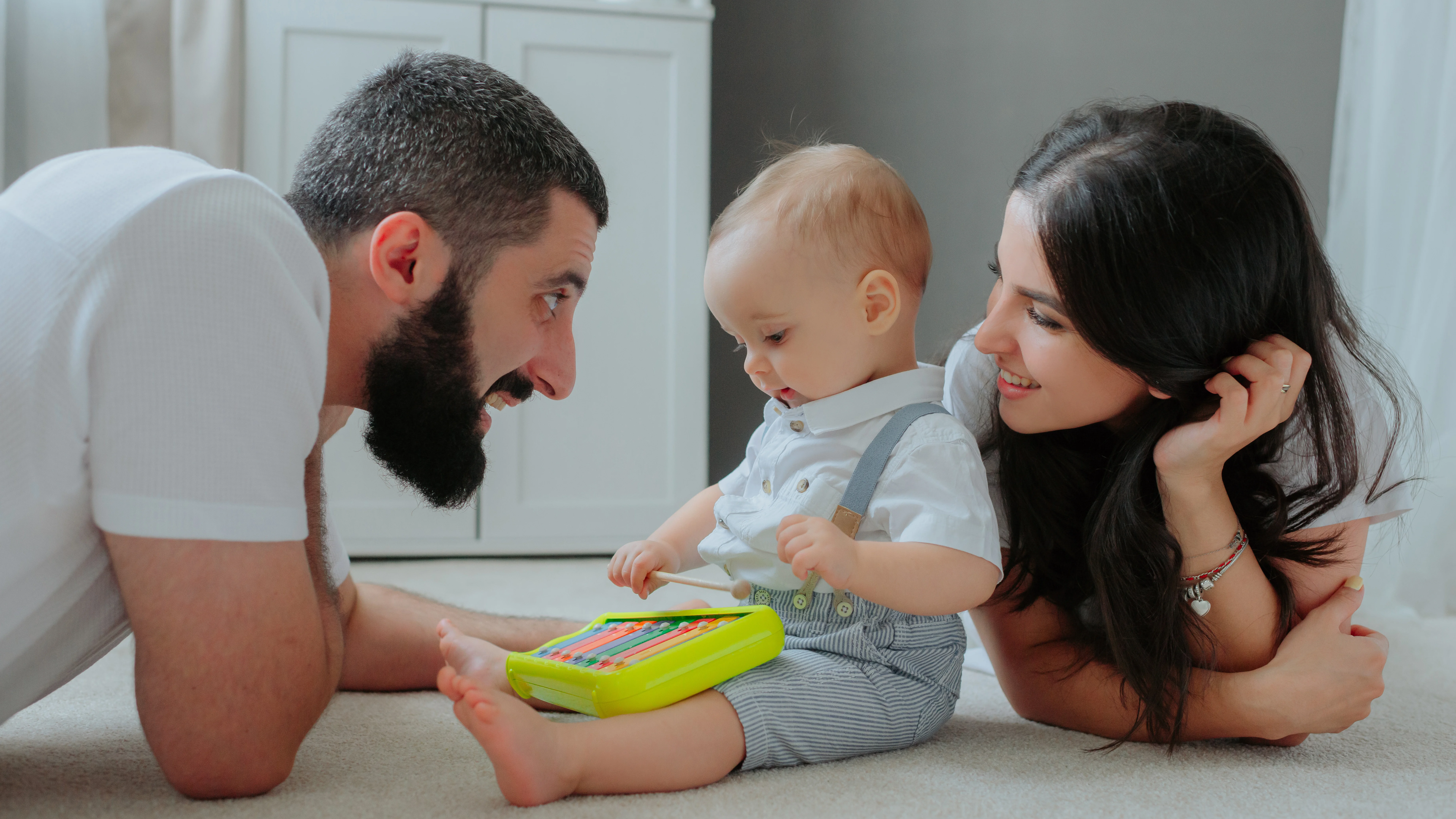 Cinematic lifestyle photography of happy relaxed parents holding a baby in a modern, sustainable home